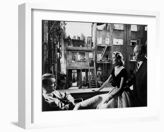 REAR WINDOW, 1954 directed byALFRED HITCHCOCK On the set, Grace Kelly between James Stewart and Alf-null-Framed Photo