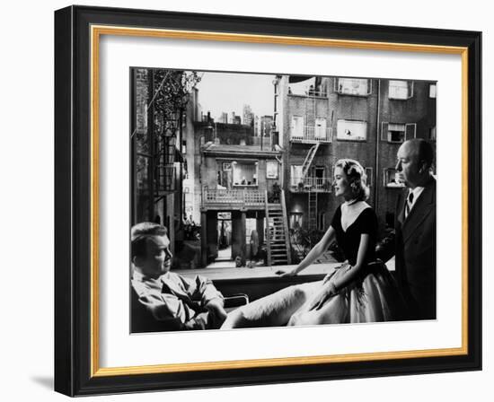 REAR WINDOW, 1954 directed byALFRED HITCHCOCK On the set, Grace Kelly between James Stewart and Alf-null-Framed Photo