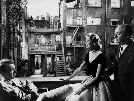 REAR WINDOW, 1954 directed byALFRED HITCHCOCK On the set, Grace Kelly  between James Stewart and Alf' Photo