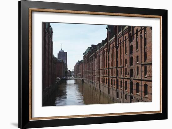 Red Brick Warehouses Overlook a Canal in the Speicherstadt District-Stuart Forster-Framed Photographic Print