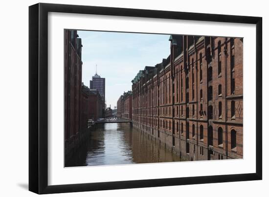 Red Brick Warehouses Overlook a Canal in the Speicherstadt District-Stuart Forster-Framed Photographic Print