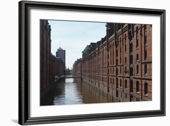 Red Brick Warehouses Overlook a Canal in the Speicherstadt District-Stuart Forster-Framed Photographic Print