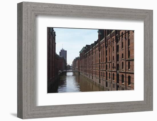 Red Brick Warehouses Overlook a Canal in the Speicherstadt District-Stuart Forster-Framed Photographic Print