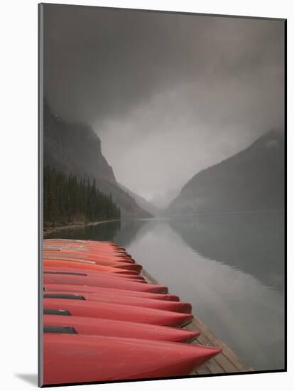 Red Canoes on Lake Louise, Banff National Park, Alberta, Canada-Walter Bibikow-Mounted Photographic Print