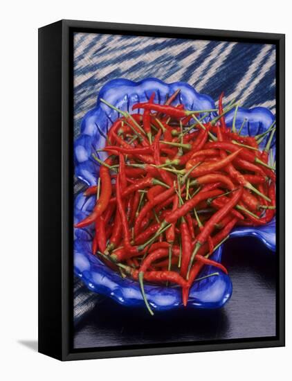 Red Chili Peppers in a Blue Bowl-Alberto Cassio-Framed Premier Image Canvas