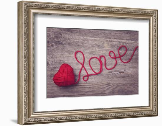 Red Heart of Red Wool Yarn on a Wooden Background-egal-Framed Photographic Print