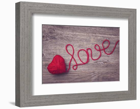 Red Heart of Red Wool Yarn on a Wooden Background-egal-Framed Photographic Print