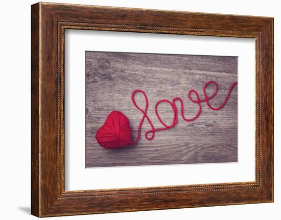 Red Heart of Red Wool Yarn on a Wooden Background-egal-Framed Photographic Print