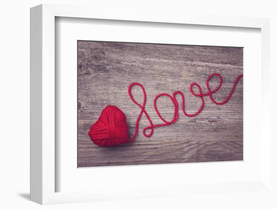 Red Heart of Red Wool Yarn on a Wooden Background-egal-Framed Photographic Print