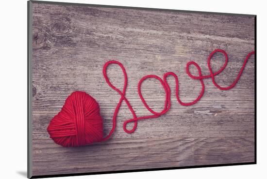 Red Heart of Red Wool Yarn on a Wooden Background-egal-Mounted Photographic Print