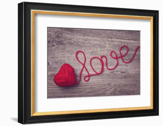 Red Heart of Red Wool Yarn on a Wooden Background-egal-Framed Photographic Print