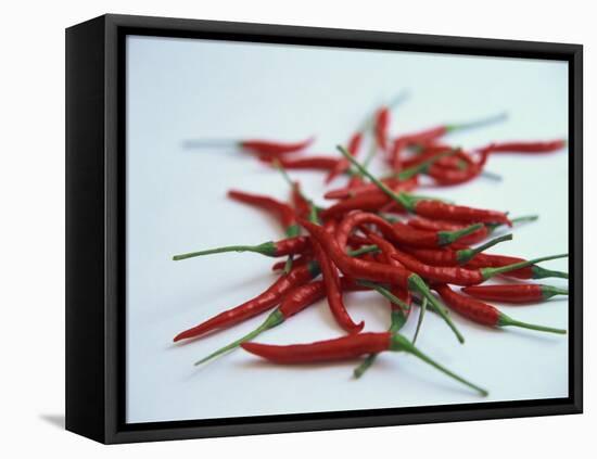 Red Hot Chillies on a White Sheet-Charcrit Boonsom-Framed Premier Image Canvas