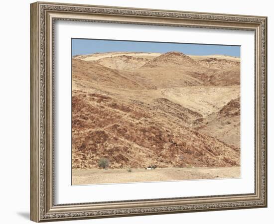 Red Rocky Landscape with Jeep in Distance, Purros Conservancy Wilderness, Kaokoland, Namibia-Kim Walker-Framed Photographic Print