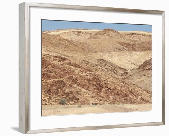 Red Rocky Landscape with Jeep in Distance, Purros Conservancy Wilderness, Kaokoland, Namibia-Kim Walker-Framed Photographic Print