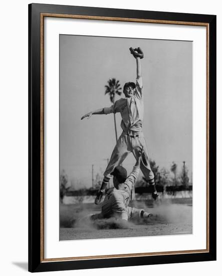 Red Sox's Player in Mid Air Catching the Ball, While an Opposing Player Slides Between His Legs-John Florea-Framed Premium Photographic Print