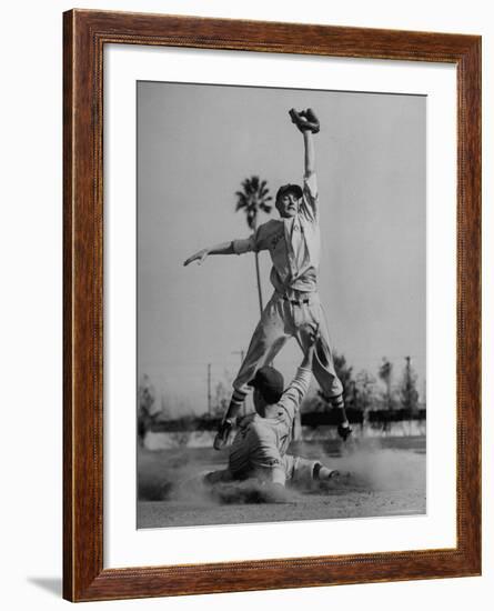 Red Sox's Player in Mid Air Catching the Ball, While an Opposing Player Slides Between His Legs-John Florea-Framed Premium Photographic Print