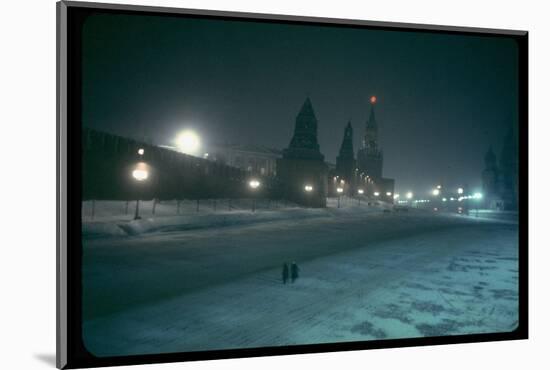 Red Star Atop Kremlin Tower Glowing Against Night-Dim Sky in Snow-Covered, Wintry Moscow, Ussr-Carl Mydans-Mounted Photographic Print