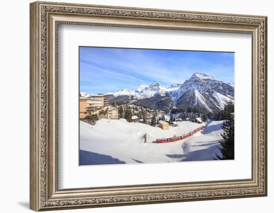 Red train of Rhaetian Railway passes in the snowy landscape of Arosa, district of Plessur, Canton o-Roberto Moiola-Framed Photographic Print