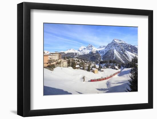 Red train of Rhaetian Railway passes in the snowy landscape of Arosa, district of Plessur, Canton o-Roberto Moiola-Framed Photographic Print