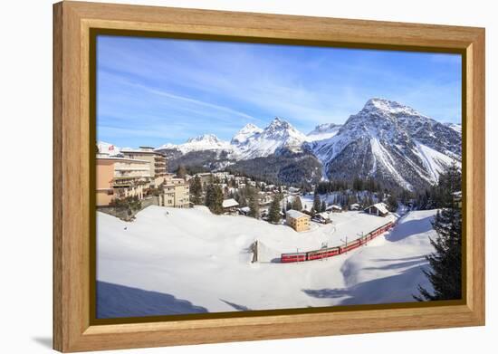 Red train of Rhaetian Railway passes in the snowy landscape of Arosa, district of Plessur, Canton o-Roberto Moiola-Framed Premier Image Canvas