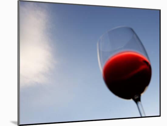 Red Wine Glass Against a Blue Sky, Paris, France-Michele Molinari-Mounted Photographic Print