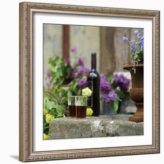 Red Wine Glasses & Red Wine Bottle on Stone Trough with Flowers-Christine Gill?-Framed Photographic Print