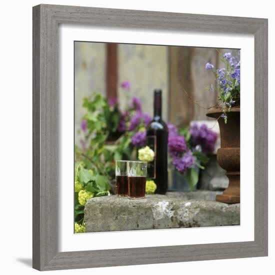 Red Wine Glasses & Red Wine Bottle on Stone Trough with Flowers-Christine Gill?-Framed Photographic Print