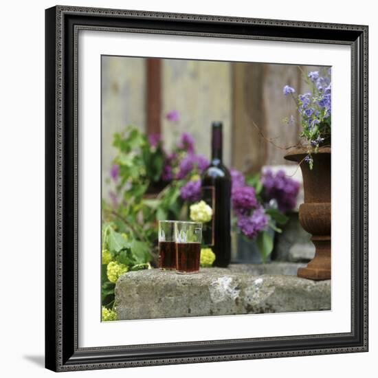 Red Wine Glasses & Red Wine Bottle on Stone Trough with Flowers-Christine Gill?-Framed Photographic Print