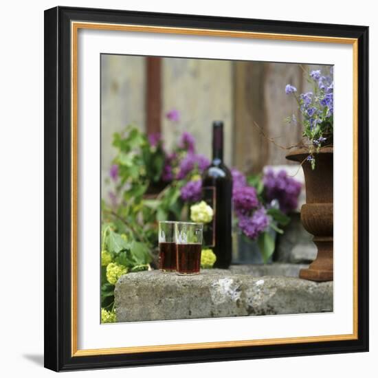 Red Wine Glasses & Red Wine Bottle on Stone Trough with Flowers-Christine Gill?-Framed Photographic Print