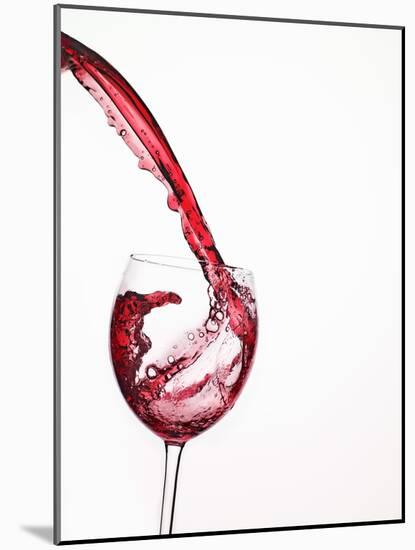 Red Wine Pouring into a Glass from Bottle-null-Mounted Photographic Print