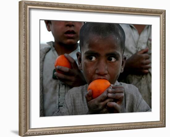 Refugee Boys Eat Tangerines at a Small Refugee Camp-null-Framed Photographic Print