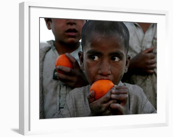 Refugee Boys Eat Tangerines at a Small Refugee Camp-null-Framed Photographic Print