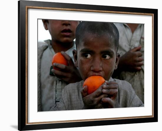 Refugee Boys Eat Tangerines at a Small Refugee Camp-null-Framed Photographic Print