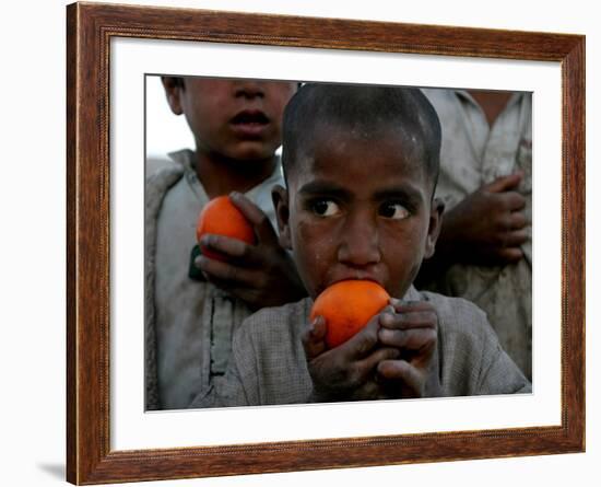 Refugee Boys Eat Tangerines at a Small Refugee Camp-null-Framed Photographic Print