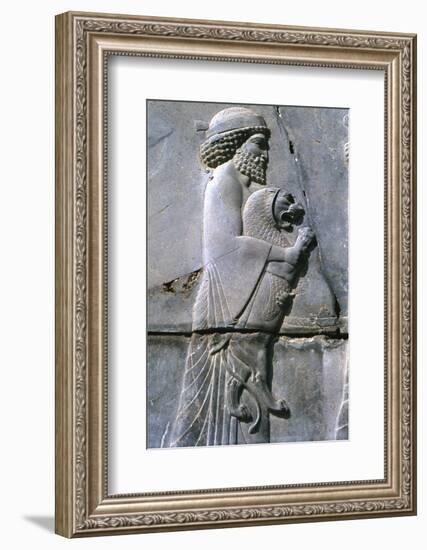 Relief of a man holding a lion cub, Persepolis, Iran-Vivienne Sharp-Framed Photographic Print