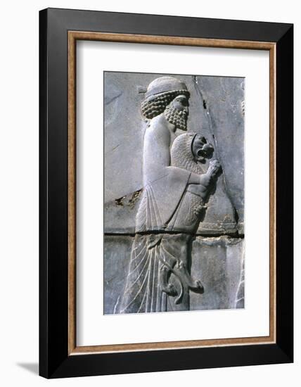 Relief of a man holding a lion cub, Persepolis, Iran-Vivienne Sharp-Framed Photographic Print