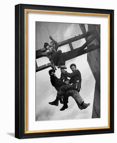 Relief Workers Hanging from Cable in Front of a Giant Beam During the Construction of Fort Peck Dam-Margaret Bourke-White-Framed Photographic Print