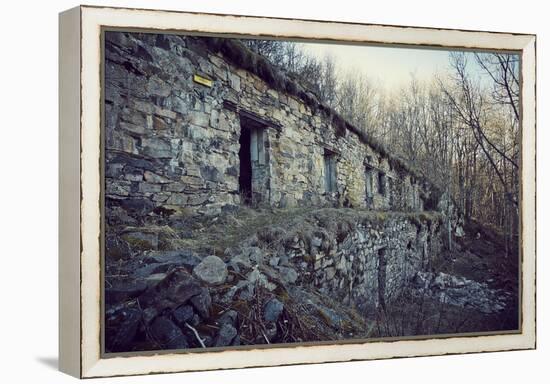 Remains of a bunker with door and windows at a mountain in a wood in winter in Alsace-Axel Killian-Framed Premier Image Canvas