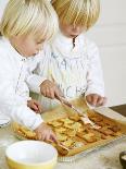 Two Children Brushing Biscuits with Glace Icing-Renate Forster-Framed Photographic Print