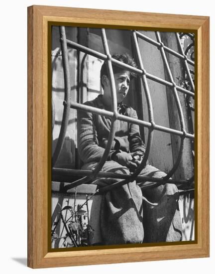 Resident of Italian Boystown Sitting in Barred Windowsill as Punishment For Wasting Bread-Hans Wild-Framed Premier Image Canvas