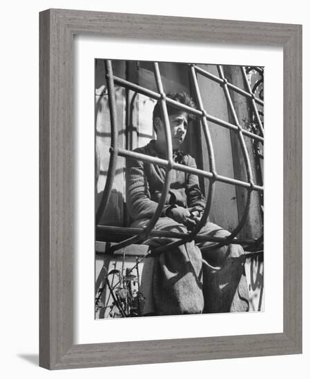 Resident of Italian Boystown Sitting in Barred Windowsill as Punishment For Wasting Bread-Hans Wild-Framed Photographic Print