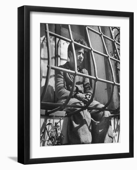 Resident of Italian Boystown Sitting in Barred Windowsill as Punishment For Wasting Bread-Hans Wild-Framed Photographic Print