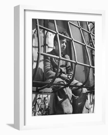 Resident of Italian Boystown Sitting in Barred Windowsill as Punishment For Wasting Bread-Hans Wild-Framed Photographic Print