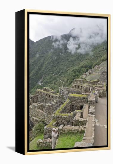 Restoration work at the Inca ruins of Machu Picchu, UNESCO World Heritage Site, Peru, South America-Julio Etchart-Framed Premier Image Canvas