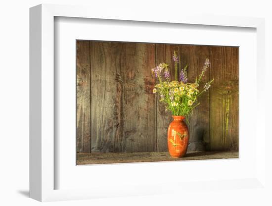Retro Style Still Life of Dried Flowers in Vase against Worn Wooden Background-Veneratio-Framed Photographic Print