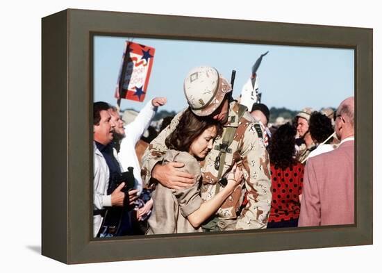 Returning US Soldier Hugs Loved One Amid Other Celebrating Families and Friends-null-Framed Stretched Canvas