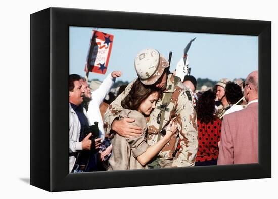 Returning US Soldier Hugs Loved One Amid Other Celebrating Families and Friends-null-Framed Stretched Canvas