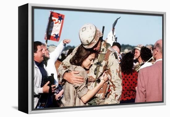 Returning US Soldier Hugs Loved One Amid Other Celebrating Families and Friends-null-Framed Stretched Canvas