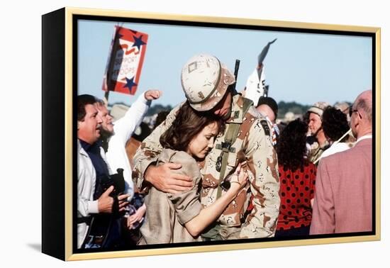 Returning US Soldier Hugs Loved One Amid Other Celebrating Families and Friends-null-Framed Stretched Canvas