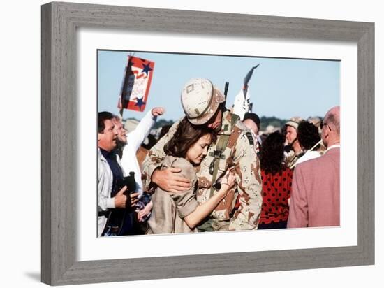 Returning US Soldier Hugs Loved One Amid Other Celebrating Families and Friends-null-Framed Photo